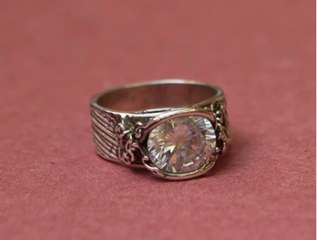 A silver ring with a clear gem in the middle